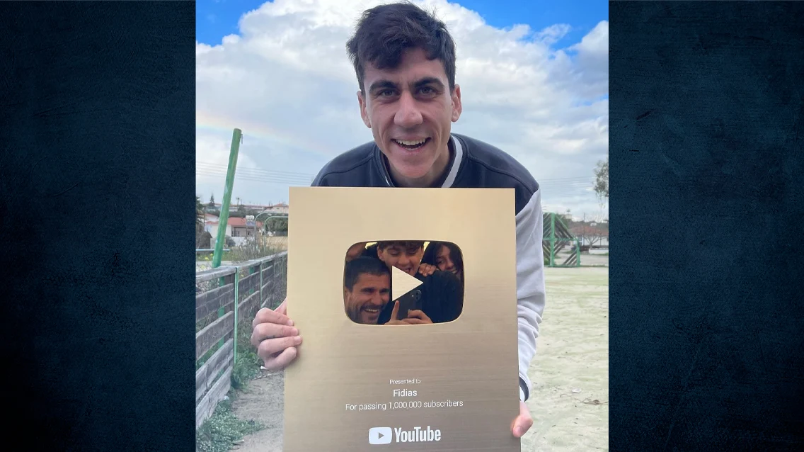 Fidias holding his YouTube Gold Creator Award for one million subscribers
